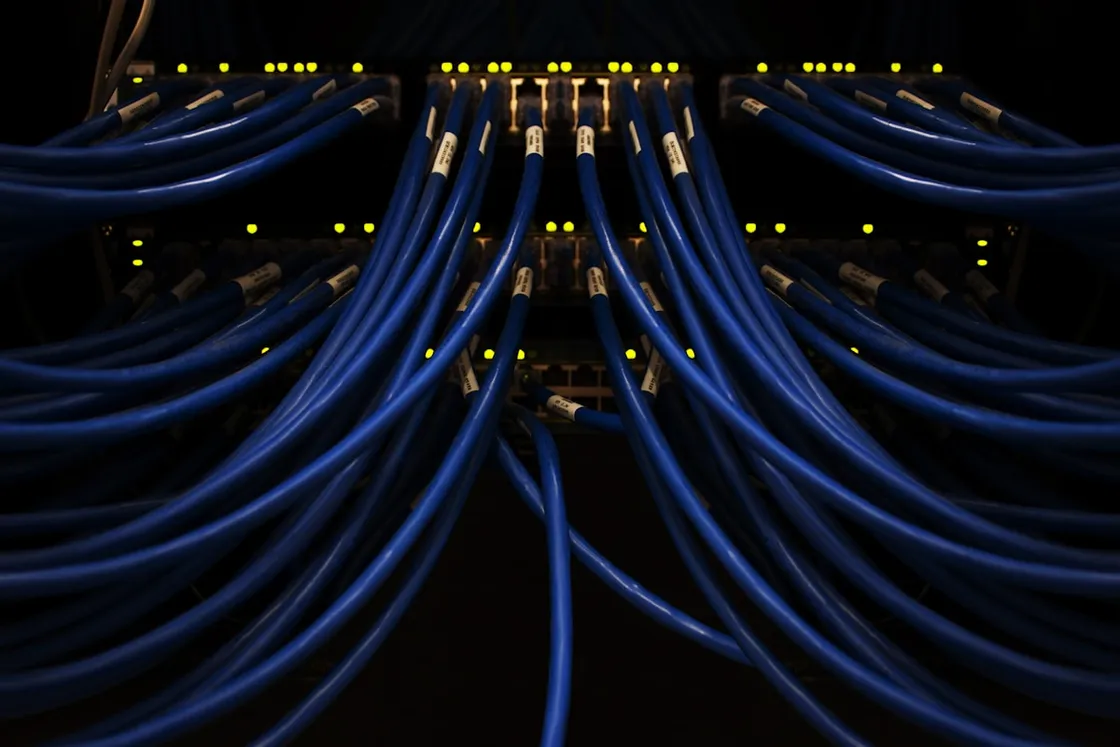 Blue network cables converging into a server switch